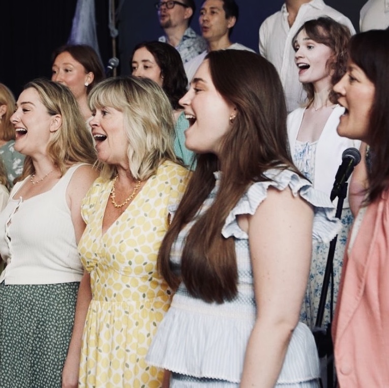 Choir members singing joyfully at the Swedish National Day celebration