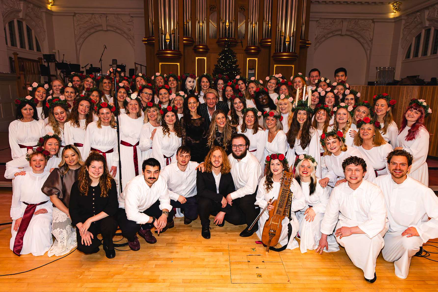 Full choir group portrait on a grand concert hall stage